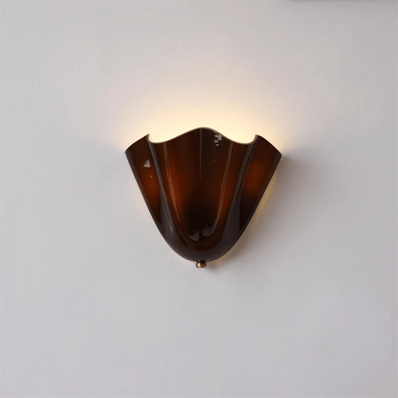 Petalia wall sconce petal form shown with warm ambient light