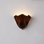Petalia wall sconce petal form shown with warm ambient light