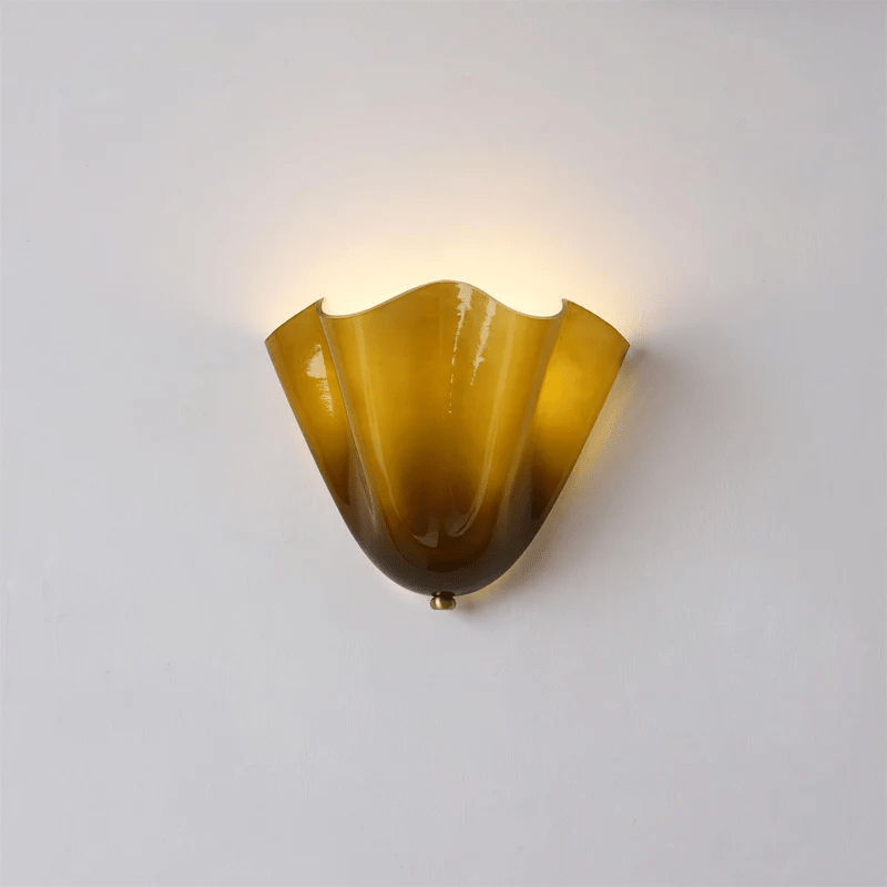 Petalia wall sconce glowing softly against a neutral wall