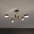 Spider chandelier with six black arms and gold-accented shades lit on a ceiling
