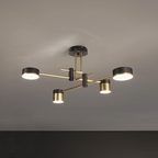 Spider chandelier with six black arms and gold-accented shades lit on a ceiling