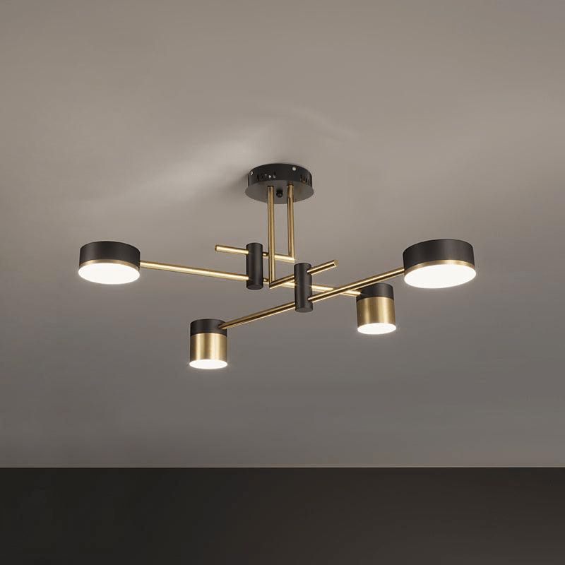 Spider chandelier with six black arms and gold-accented shades lit on a ceiling
