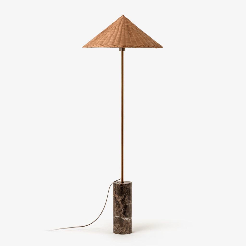Clérachic rattan cone-shade floor lamp on a slim brass stem and dark marble cylinder base, shown full length on a plain white background.