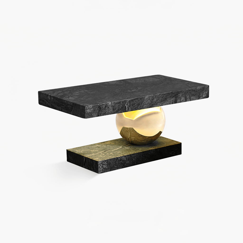 Clérachic charcoal marble table lamp with its brass sphere base, shown unlit on a plain white studio background.
