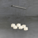 The silver six-head Ivnoros chandelier, alabaster cubes catching soft daylight against a grey wall.