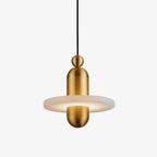 Slightly angled view of the gold Orion pendant, warm light spilling across the alabaster disc.