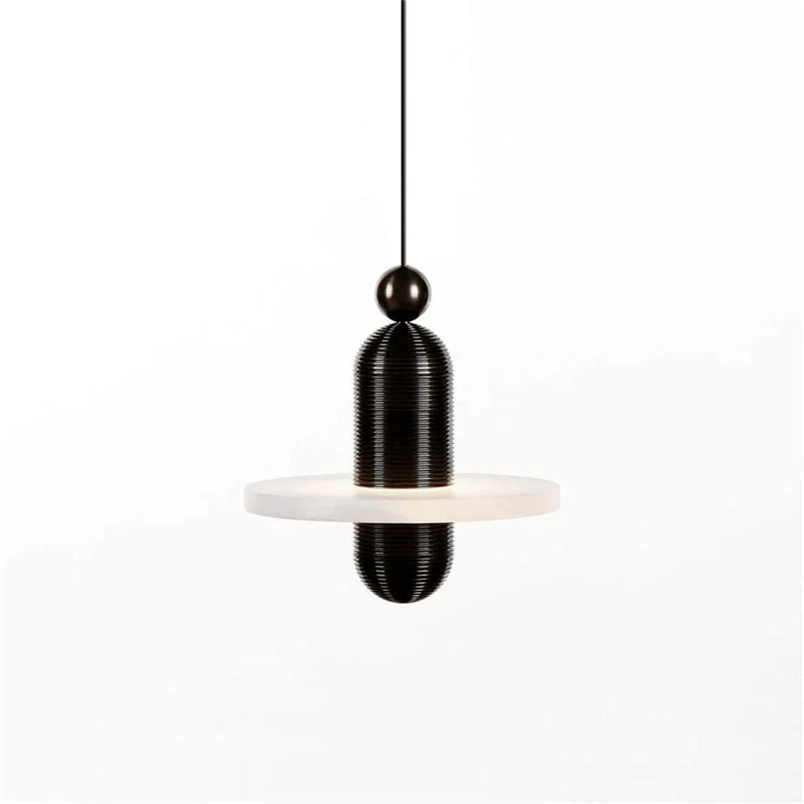 Close view of the black Orion pendant's ribbed stem and ball fitting above the alabaster disc.