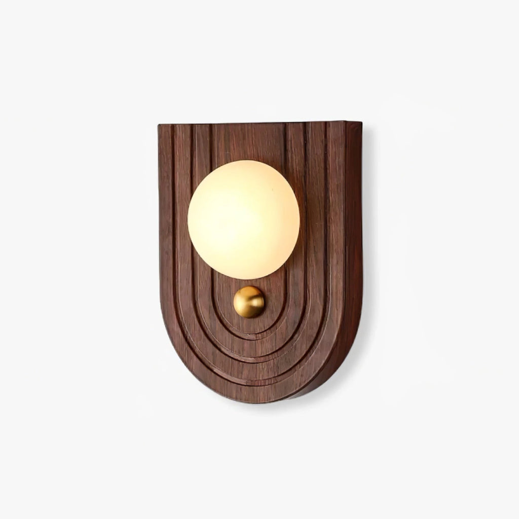 Koyan wall light with an arched, ridged walnut backplate, alabaster globe and small brass knob below.