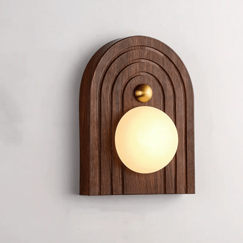 Arched walnut Koyan wall light mounted the other way up, brass knob above the alabaster globe.
