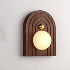Arched walnut Koyan wall light mounted the other way up, brass knob above the alabaster globe.