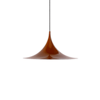Chrome arch pendant light reflecting the surrounding room