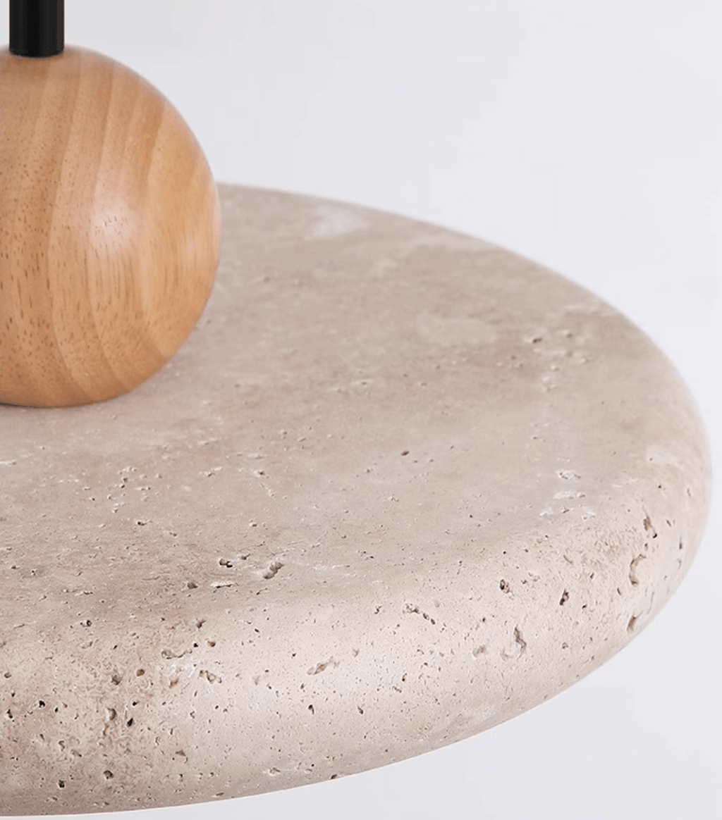 Travertine pendant light glowing warmly above a dining table