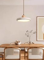 Travertine pendant light shown in warm white over a table