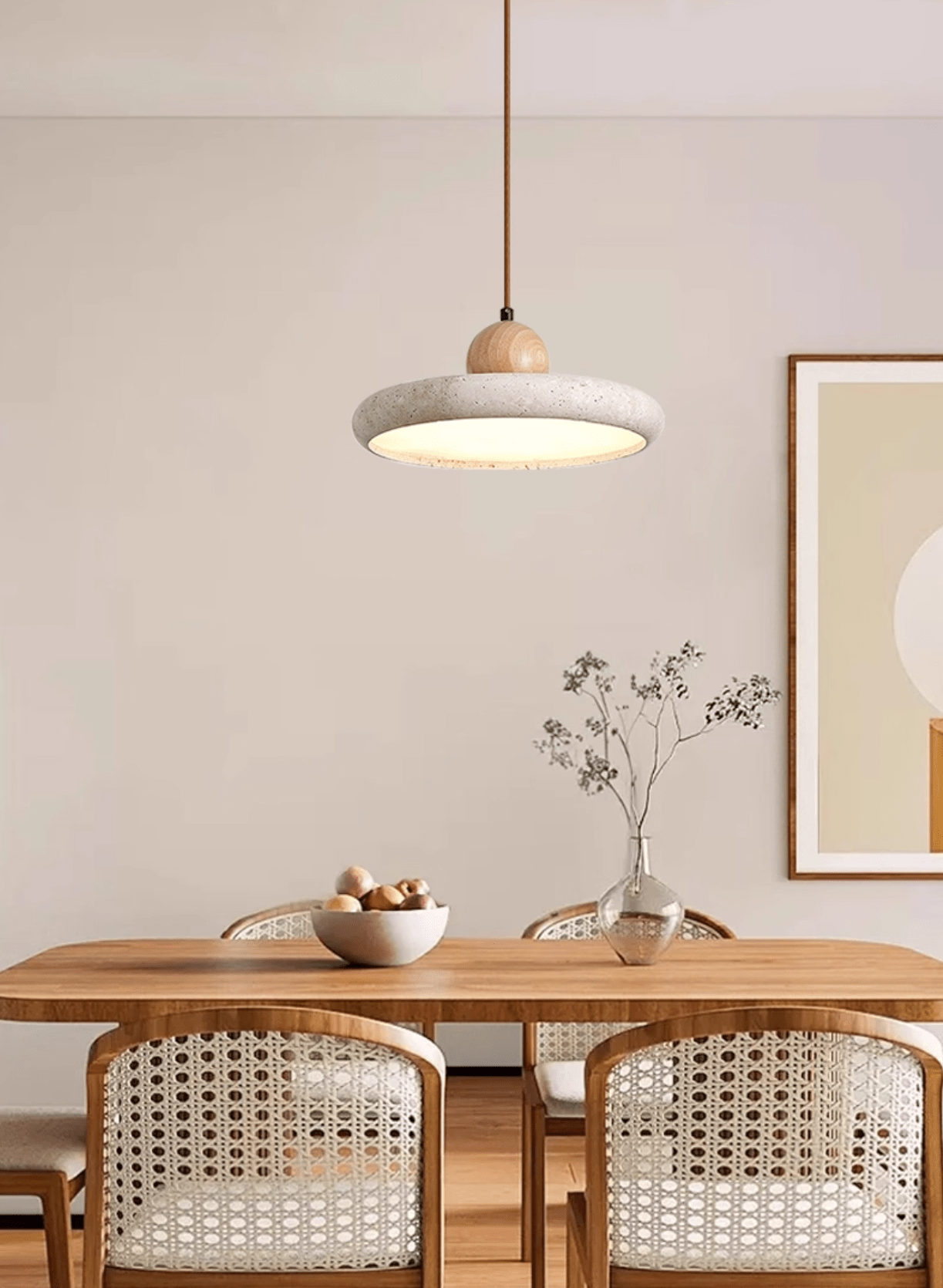 Travertine pendant light shown in warm white over a table