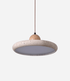 Natural stone travertine pendant light lit in a calm interior