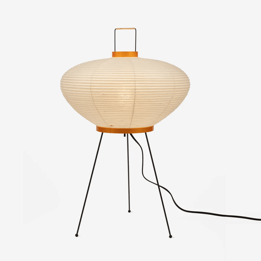 Mulberry paper table lamp glowing warmly beside soft decor