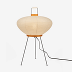 Mulberry paper table lamp glowing warmly beside soft decor