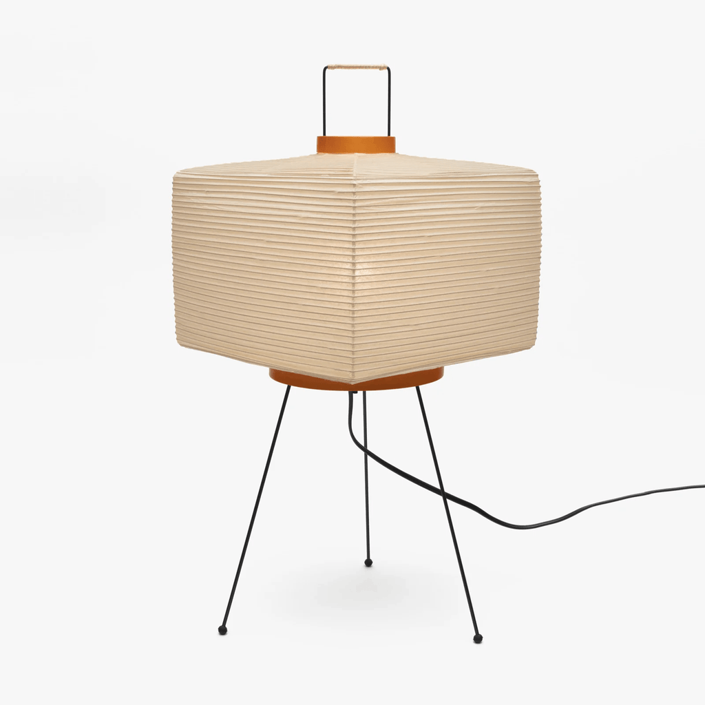 White paper lantern table lamp in a softly lit room