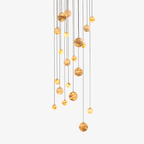 Cropped detail of the chandelier's alabaster globes, mixing larger and smaller stone spheres on fine cables.