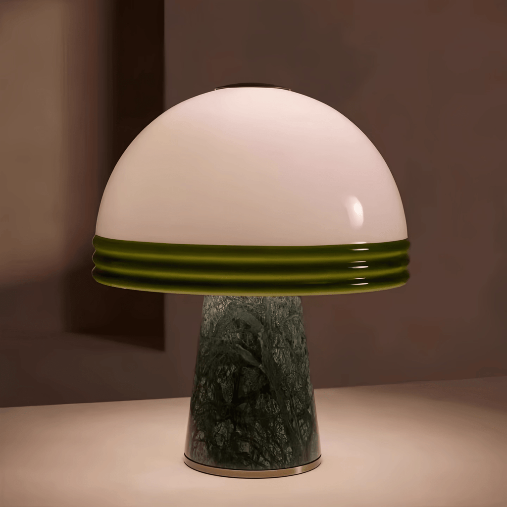 Clérachic dome table lamp photographed against a warm terracotta backdrop, showing the full green-rimmed shade and marble base.