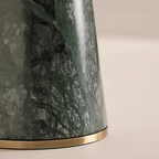 Close-up of the Clérachic table lamp's green marble base and brass trim ring, photographed from a slightly wider angle.