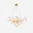 Gingko leaf chandelier with porcelain leaves glowing over a dining area