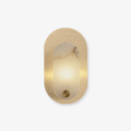 Perforated brass oval wall light on white, a lit alabaster panel set into the punched metal plate.