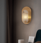 The sconce lit in the bedroom corner, seen from further back with the curtain to the left.