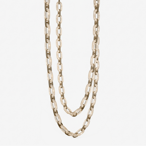 Alabaster chain-link chandelier unlit, its stone links looped in two swags on a plain backdrop