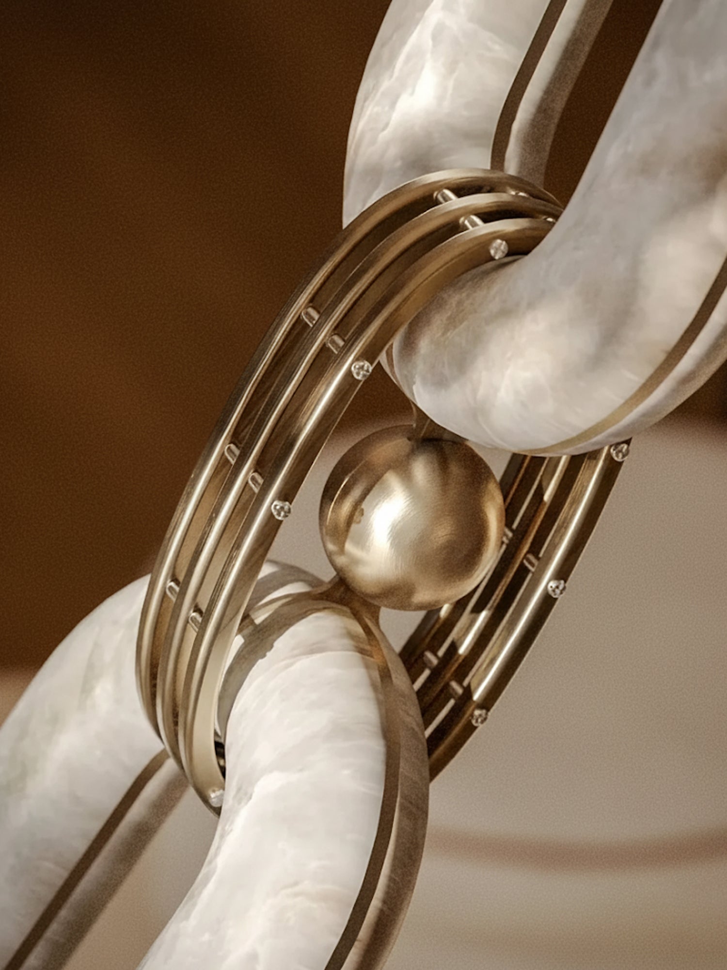 Detail of the brass ball and ringed collar joining two polished alabaster links