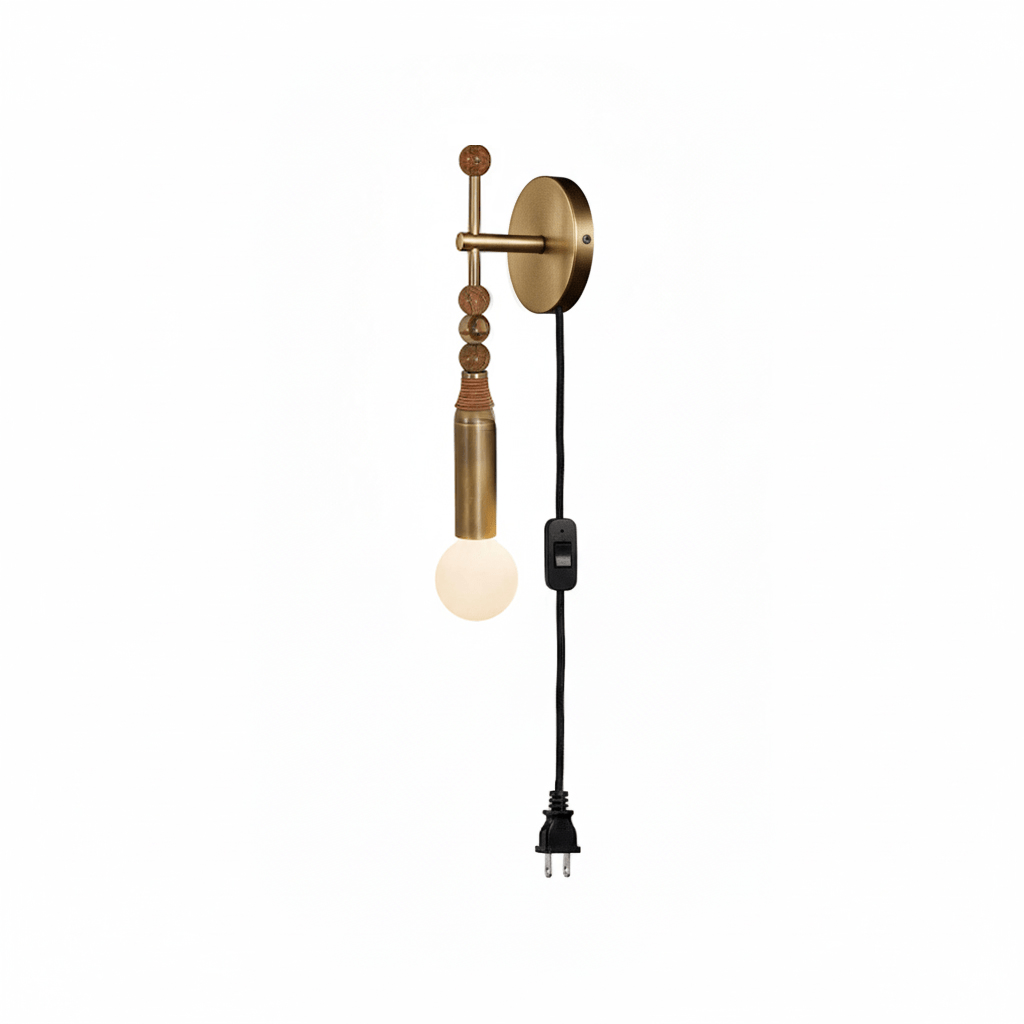 Clérachic wall sconce on white, amber beads and a leather wrap above a lit glass globe, cord ending in a plug.