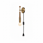 Clérachic wall sconce on white, amber beads and a leather wrap above a lit glass globe, cord ending in a plug.