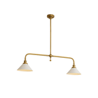 This brass-finish Clérachic pendant spreads its arms wide on white, warm light glowing from both shades.