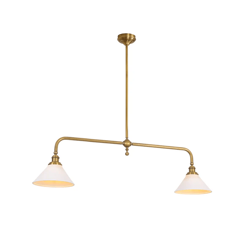 Arms swept wide above two matching shades, this brass-finish Clérachic pendant glows warm on a white background.