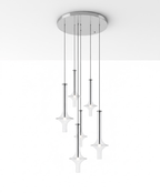 A cluster of lit Clérachic pendants in clear glass hangs from a round canopy fixed flush to a plain white ceiling corner.