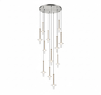 A cascade of Clérachic pendants in mixed clear and tinted glass drops from a round canopy, glowing warm against a white backdrop.