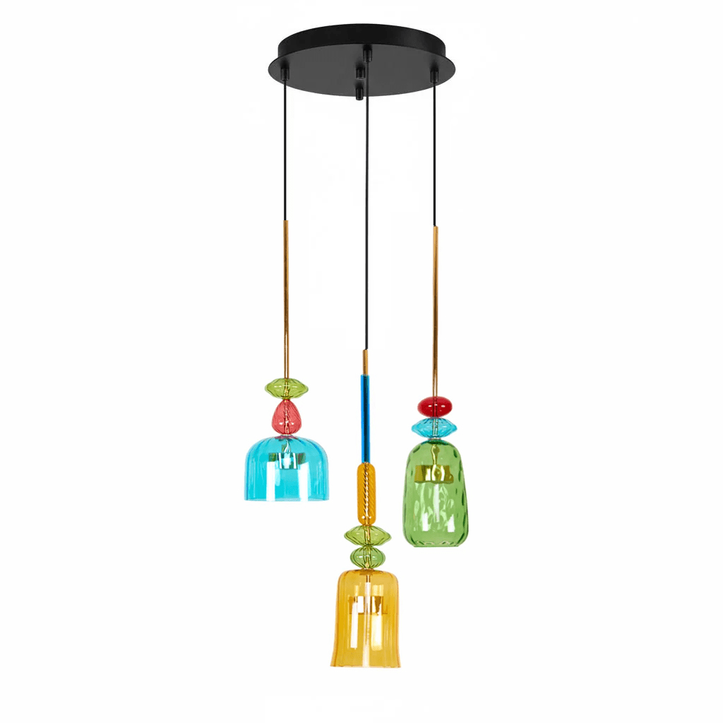 Three Clérachic pendants in teal, green and amber glass hang from a round black ceiling plate, the amber shade lowest, on white.