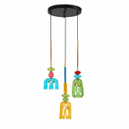 A round black ceiling plate holds teal, green and amber Clérachic pendants, the amber shade closest to camera, shown on white.