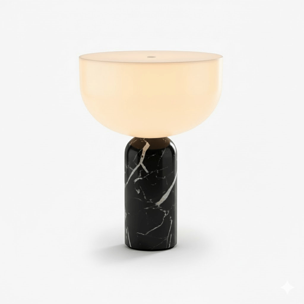 This Clérachic sphere table lamp in black marble, lit and photographed against a plain light grey background.