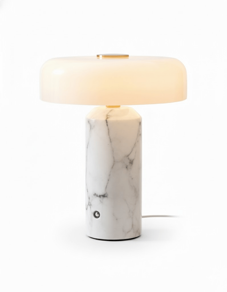 Marble table lamp glowing with a soft opaline shade