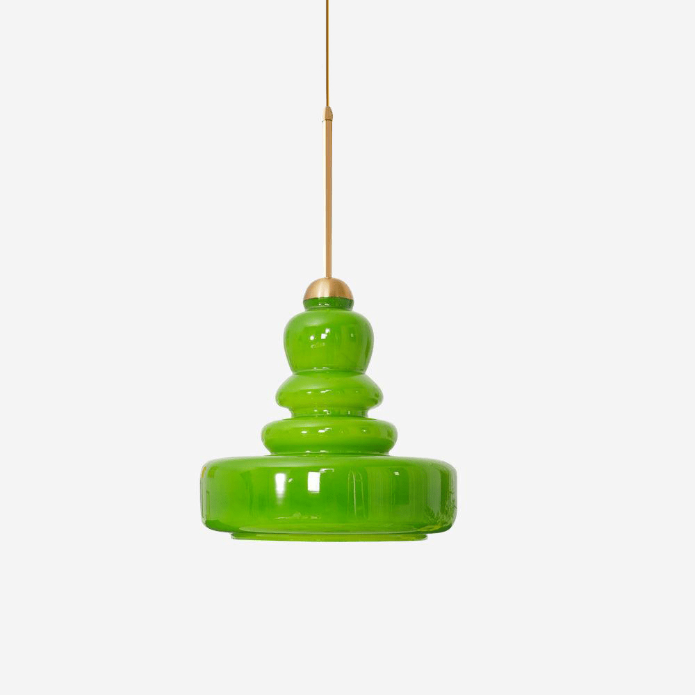 Glass schoolhouse pendant lit warmly against a pale wall