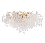 Unlit on a white background, this Clérachic ceiling light shows its full spread of gold branches and frosted glass discs from the front.