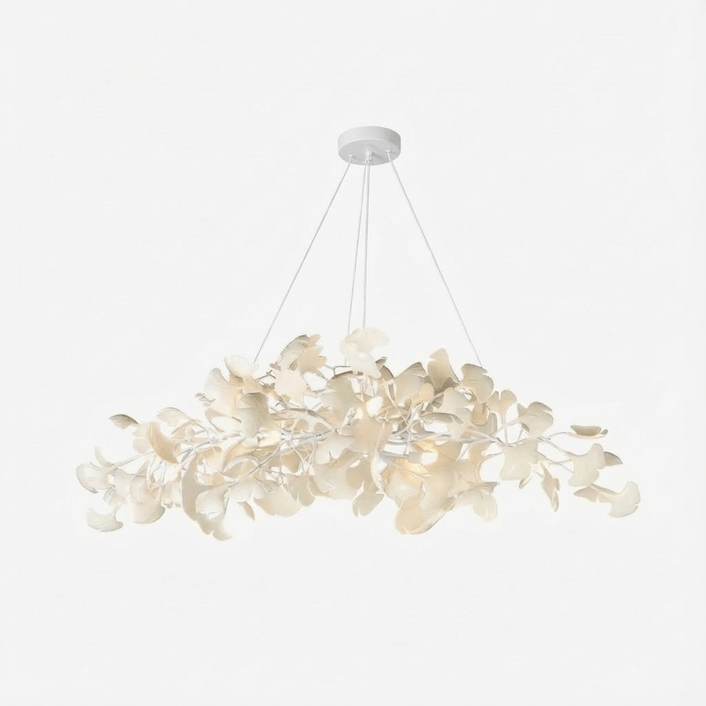 Dense leaf chandelier glowing above a dining table