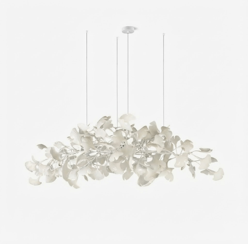 Dense ginkgo leaf chandelier casting warm light from above