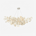 Gingko leaf chandelier shown lit against a dark backdrop