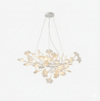 Gingko leaf chandelier shown spread wide above a staircase
