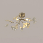 White ceramic ginkgo leaves fanned around glowing G9 globes