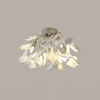 Close view of white ceramic leaves catching warm light