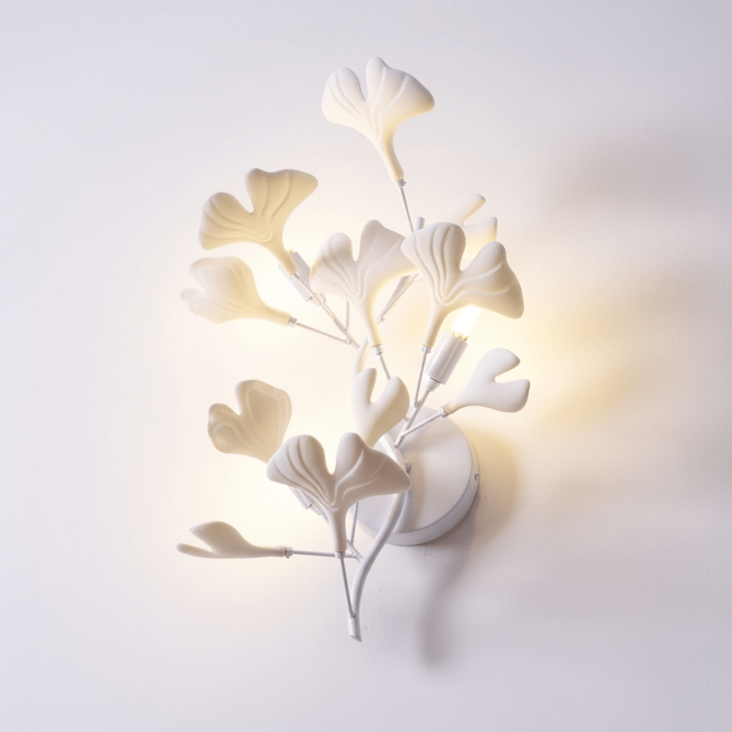 Detail of white ceramic ginkgo leaves on a gold frame