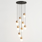 A full spiral of travertine and glass spheres cascades from this multi-light Clérachic pendant's round canopy.